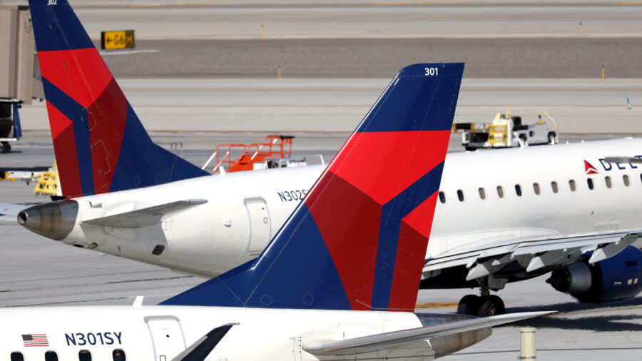 Two Delta Airlines planes pass by each other on the tarmac at Salt Lake City International Airport ...