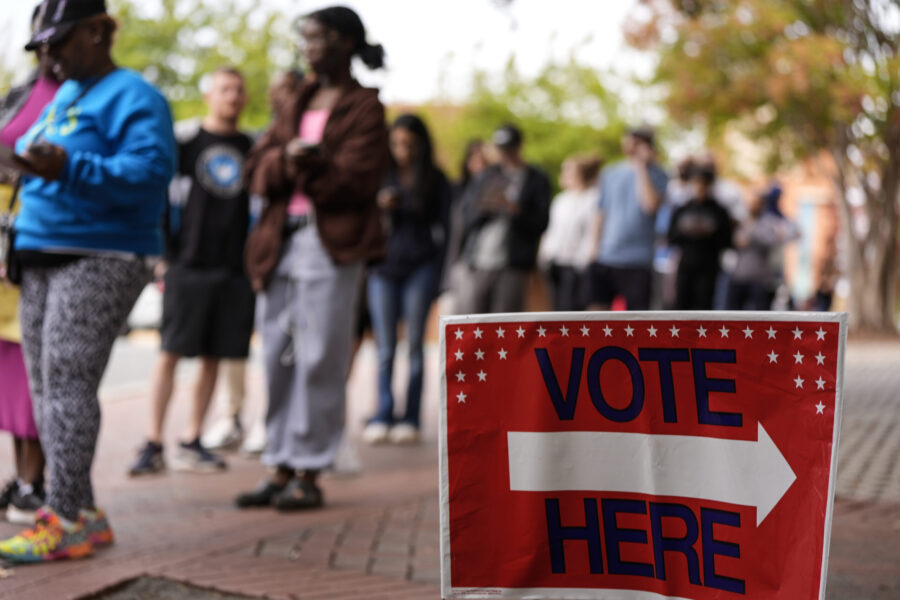 People stand in line during the last day of early voting, Saturday, Nov. 2, 2024, in Charlotte, N.C...